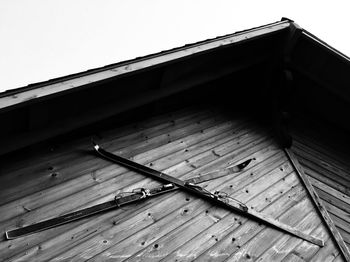 Low angle view of house roof against clear sky