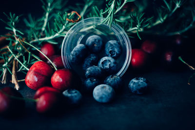 Close-up of fruits with rosemary on table