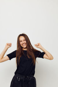 Young woman standing against white background