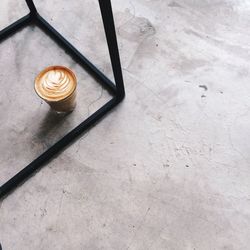 High angle view of coffee in glass below table