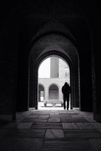 Woman walking in archway