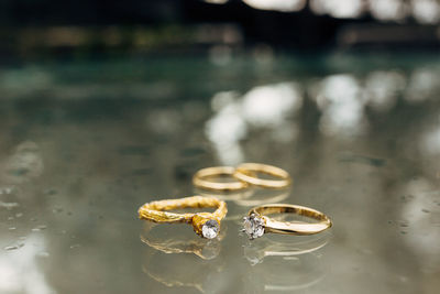 Close-up of wedding rings on glass