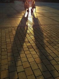 Low section of father and son walking on footpath