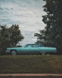 Cars on field against sky