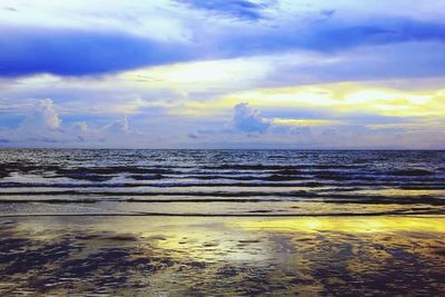Scenic view of sea against cloudy sky