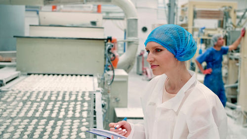 Portrait of woman working in factory