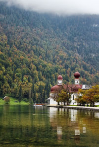 Scenic view of lake by trees and mountains