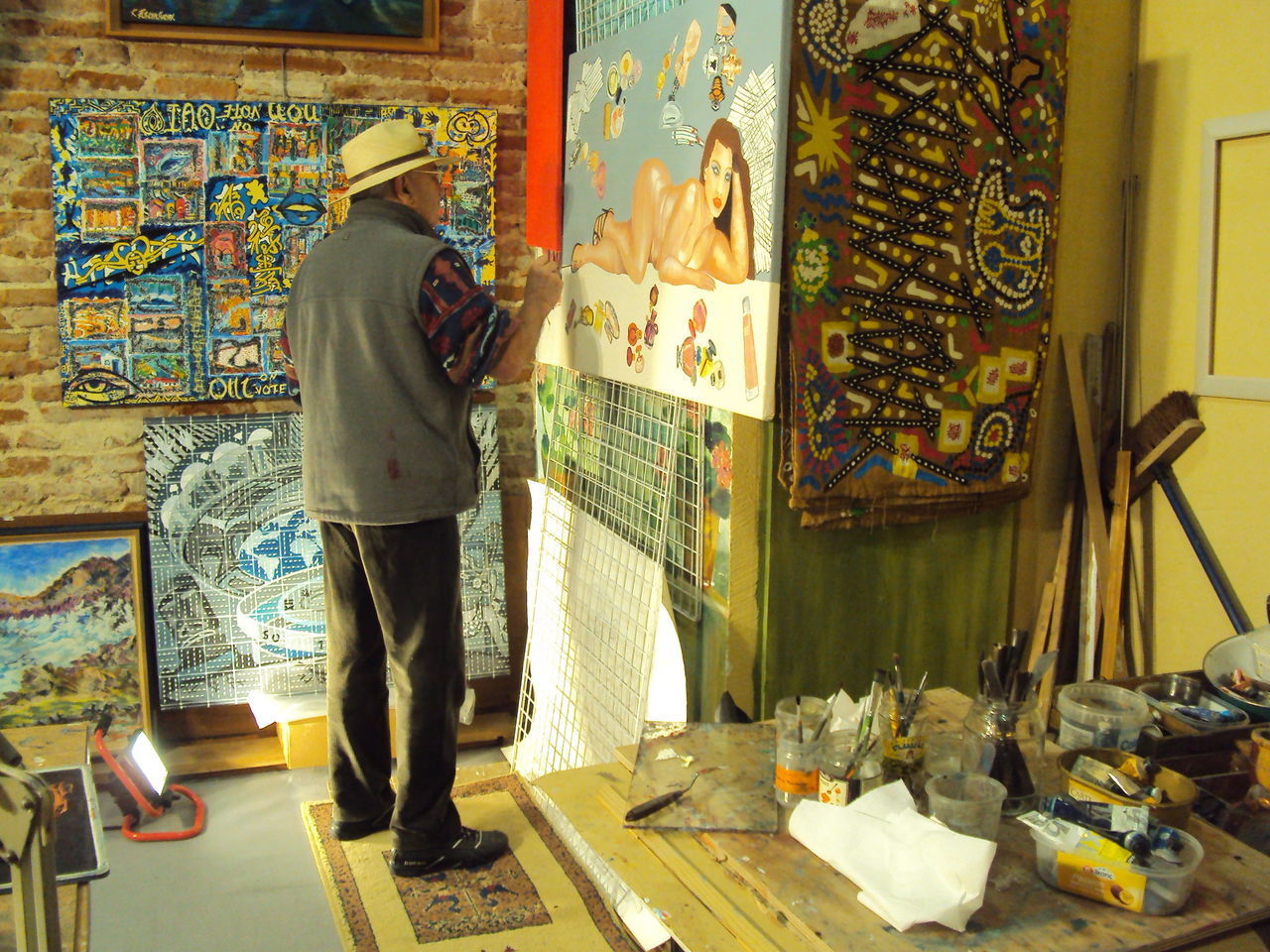 FULL LENGTH REAR VIEW OF MAN STANDING AT MULTI COLORED INDOORS