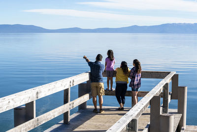 A family on a pier on a beautiful day in south lake tahoe, ca