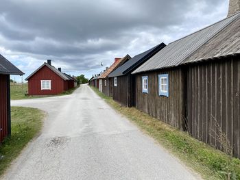 Road amidst buildings against sky