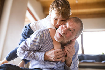 Grandfather and grandson having fun at home