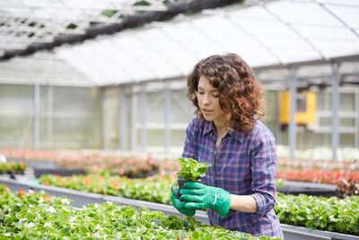 Woman working in greenhouse