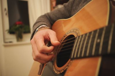 Close-up of man playing guitar