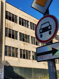 Low angle view of road sign against sky