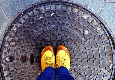 Low section view of man standing on manhole