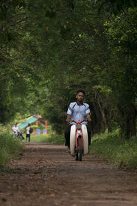 Full length of a man riding scooter