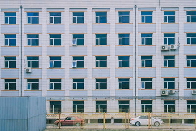 Cars on road against building