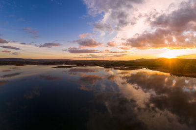 Drone aerial view of a lake reservoir of a dam with reflection on the water in sabugal, portugal