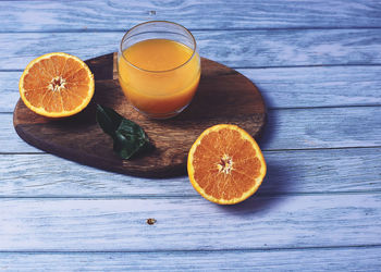 Orange fruits in glass on table