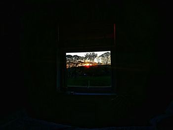 Illuminated building seen through window