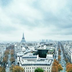 Cityscape against cloudy sky