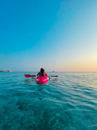 Man in boat on sea against sky