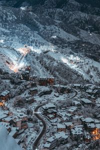 High angle view of road amidst buildings in city during winter