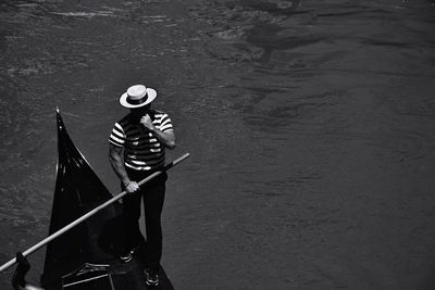 High angle view of person standing by boat in canal