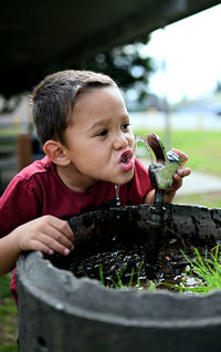 Portrait of boy drinking water