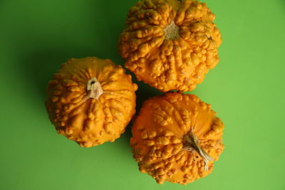 Close-up of orange fruit on yellow background
