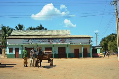 View of horse in town square against sky