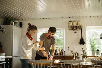 Couple preparing cinnamon buns