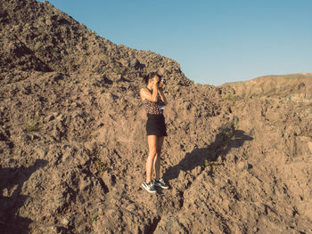 Rear view of woman against clear sky