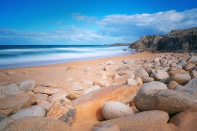 Rocks on beach against sky