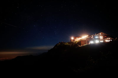Low angle view of illuminated building against sky at night