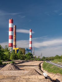 View of factory against blue sky