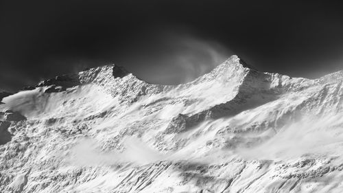 Low angle view of snow mountain against sky