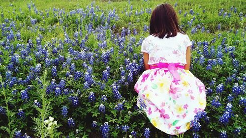 Woman holding flowers in garden