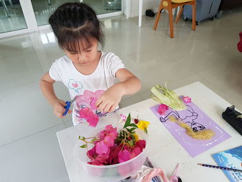 High angle view of girl holding table