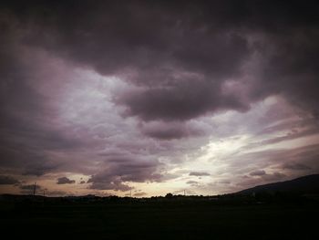 Scenic view of landscape against cloudy sky