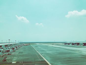 Empty airport runway against sky