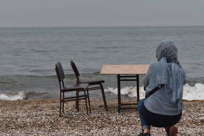 Rear view of woman looking at sea shore