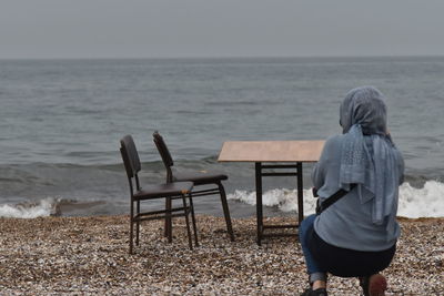 Rear view of woman looking at sea shore