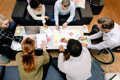 High angle view of sales executives planning business opportunities at work place