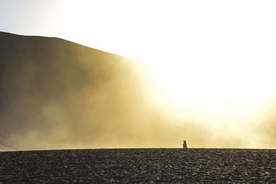 Man standing on beach against sky