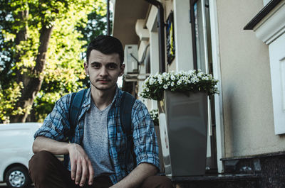 Portrait of man sitting outdoors