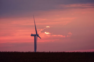 Low angle view of windmill against sky during sunset