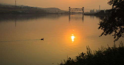 Scenic view of lake against sky during sunset