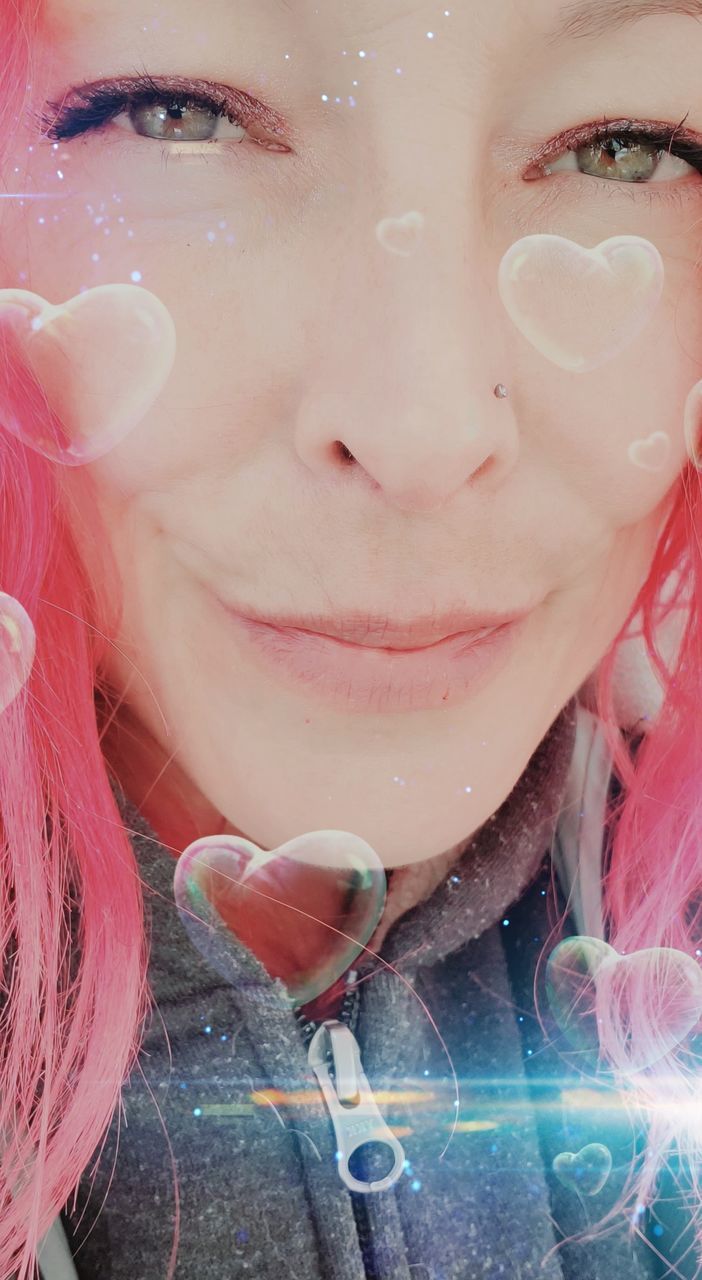 CLOSE-UP PORTRAIT OF YOUNG WOMAN HOLDING PINK FLOWER