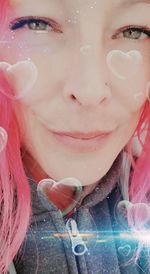 Close-up portrait of woman holding pink flowers